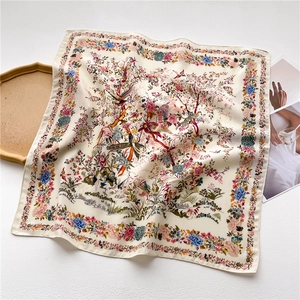 Elegant off-white square silk scarf with floral and bird prints on textured background