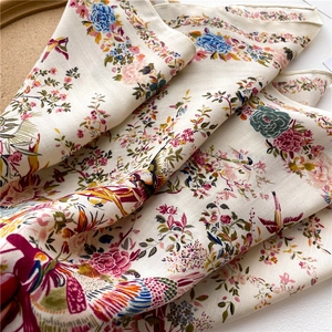 Silk square scarf with floral bird print and herringbone texture on beige background