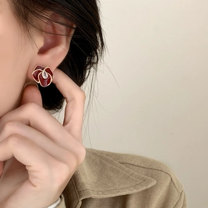 Elegant vintage red flower stud earrings with gold trim and crystal on model