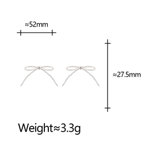 Detailed view of silver bow-shaped earrings with beaded texture and dimensions