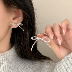 Elegant beaded bow earrings with transparent abacus beads in a minimalist luxury style