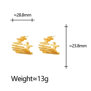 Golden irregular wavy C-shaped hoop earrings with ridged texture and measurement details