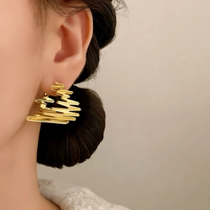 Elegant gold-plated geometric twist stud earrings with irregular layered wave design