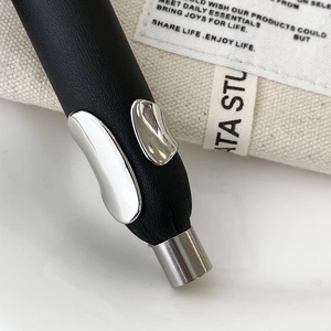 Macro shot of minimalist black matte ring with asymmetric shiny silver metal elements