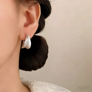 Elegant matte silver C-shape multi-layer arched stud earrings for women on model