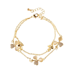 Double-layered gold bracelet with cat eye stone petals and cubic zirconia clover charms