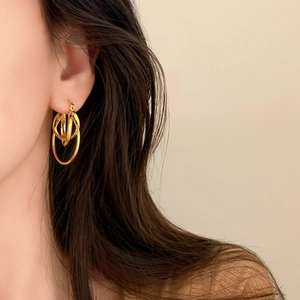 Elegant multi-layered gold hoop earrings for women showing layered circular design