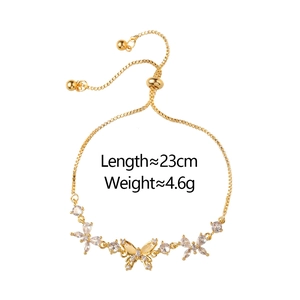 Adjustable golden butterfly bracelet with cubic zirconia and flower motif detailing