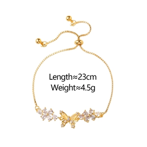 Elegant gold butterfly bracelet with white zircon flower accents on a white background