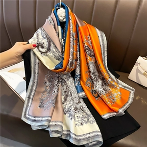 Close-up of luxury large silk scarf with paisley patterns and satin glossy texture