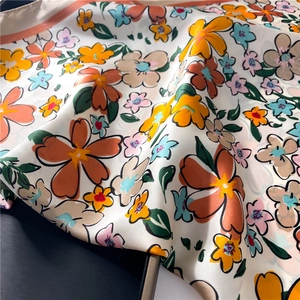 Macro detail of floral satin scarf texture with vibrant flower prints and silky luster