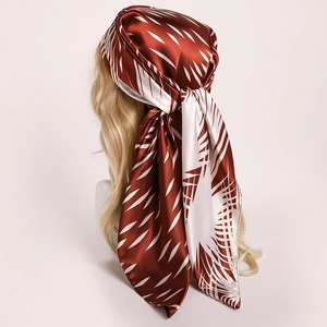 Elegant wine red and beige striped satin silk square scarf worn as a stylish headband