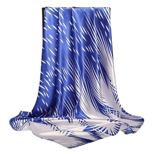 Minimalist satin silk scarf with abstract blue ink pattern on white background