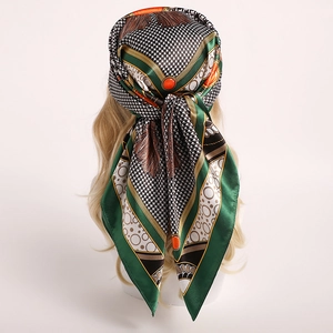 Houndstooth pattern satin silk scarf tied on head with green and gold geometric design