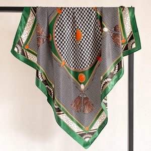 Detail of green border silk scarf with black white houndstooth and vintage jewel print