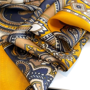 Macro detail of silk-like paisley scarf fabric with geometric pattern and rich luster