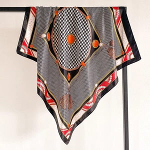 Detail of satin square scarf featuring houndstooth pattern and jewel tassel prints