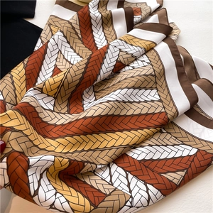 Detailed view of the woven rope pattern on a 90cm square satin silk scarf with rich colors