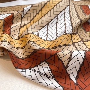 Macro shot of colorful twill silk scarf with woven rope pattern and detailed fabric texture