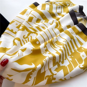 Detail of silk-like twill scarf showing soft satin texture and geometric print