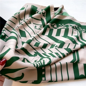 Close-up of vintage floral twill silk scarf with geometric patterns and numerical motifs