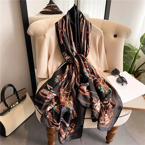 Detailed view of large silk scarf featuring elegant equestrian prints with horse bits