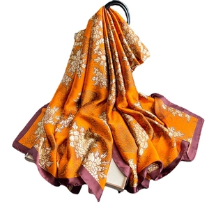 Luxurious large silk shawl with golden peony flower patterns on bright orange-yellow fabric