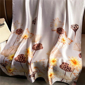 Elegant lotus pond floral print long silk scarf draped over a classic leather chair