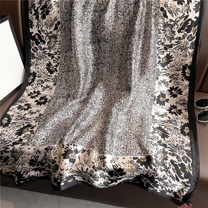 Luxurious black and white floral silk scarf with elegant wide border and satin finish