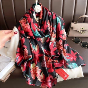Floral and maple leaf print silk scarf in gradient colors used as a stylish long shawl