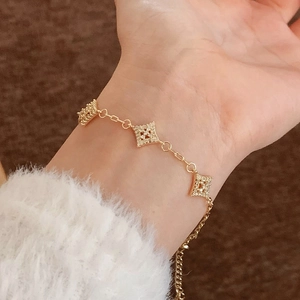 Elegant gold chain bracelet with three micro-set zircon square charms on a model wrist