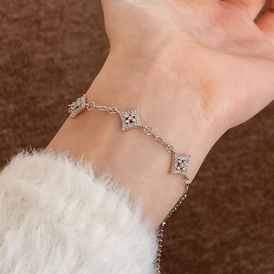 Elegant silver star bracelet with micro-pave zircons on a cozy knit sleeve background