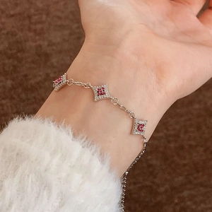Elegant silver star bracelet with micro-pave zircons and red gemstones on wrist