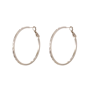 Elegant silver textured hoop earrings with a diamond-cut pattern and minimalist round design