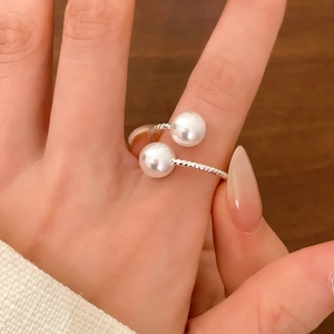 Silver twisted rope ring featuring two lustrous white pearls in a bypass wrap design