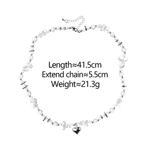 Detail of beaded necklace with silver heart pendant and adjustable sizing guide