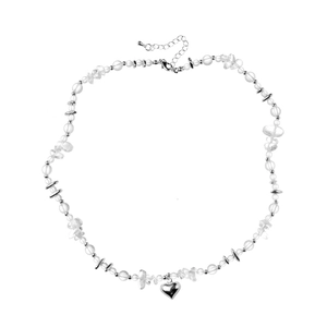 Minimalist clear beaded necklace with a metallic heart pendant and adjustable silver clasp