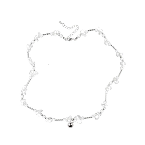 Detail view of clear glass beads and silver metal ball pendant on minimalist necklace
