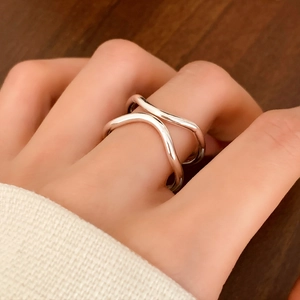 Minimalist double-layered silver wave ring for women, stylish open-band design worn on finger