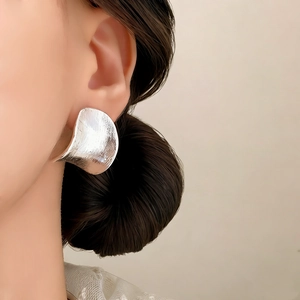 Artistic silver-plated arched stud earrings with brushed metal finish for a modern look