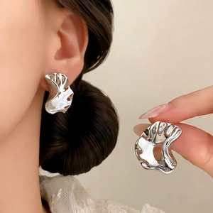 Minimalist silver irregular wave earrings with polished finish and modern pleated design