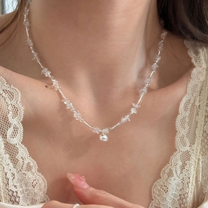 Minimalist clear crystal beaded necklace featuring a polished silver sphere pendant