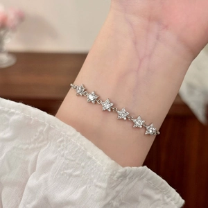 Elegant silver star bracelet with shimmering cubic zirconia stones on female wrist