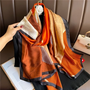 Luxury color block silk scarf with orange houndstooth pattern and geometric design