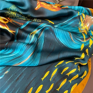 Luxurious long silk shawl with golden deer and fish prints on a deep blue background