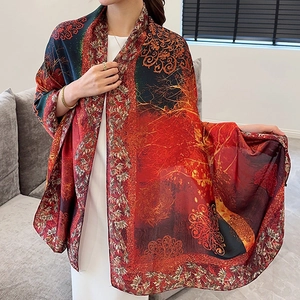 Close-up of luxury red shawl with vintage floral patterns and soft fabric drape