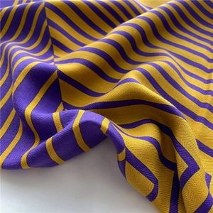 Detail of purple and ginger yellow herringbone striped fabric with soft weave texture