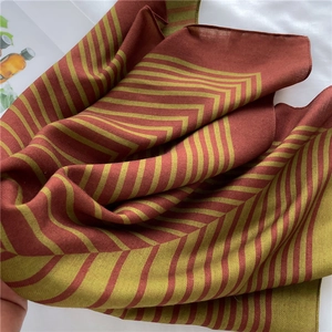 Detailed view of striped herringbone pattern on soft burgundy and olive green silk scarf