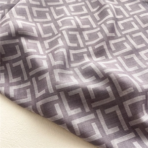 Macro detail of herringbone pattern fabric on a soft mauve silk-like square scarf