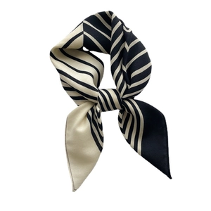 Elegant black and white striped satin square scarf styled in a soft decorative neck tie